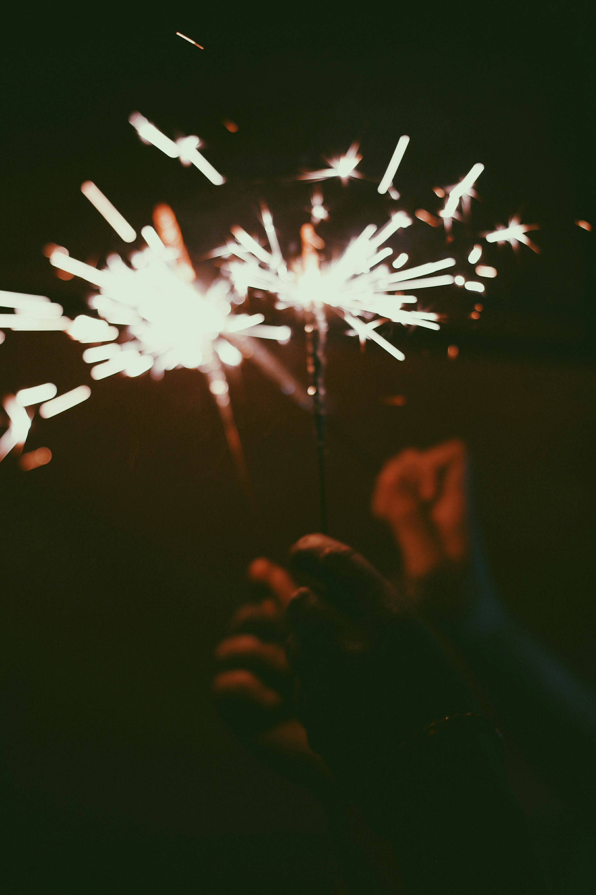 person holding white and red fireworks