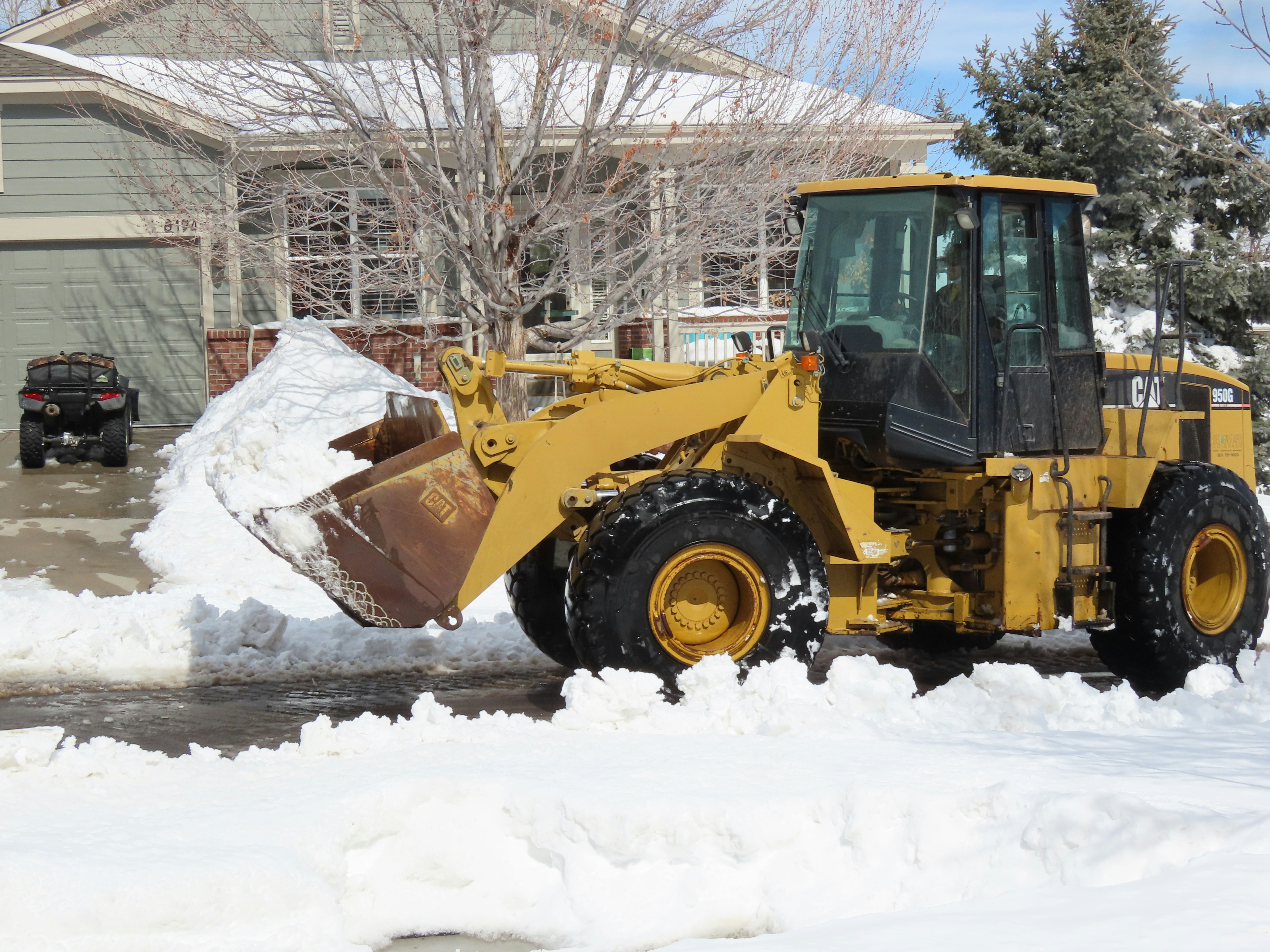 yellow and black heavy equipment on snow covered ground