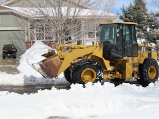 yellow and black heavy equipment on snow covered ground