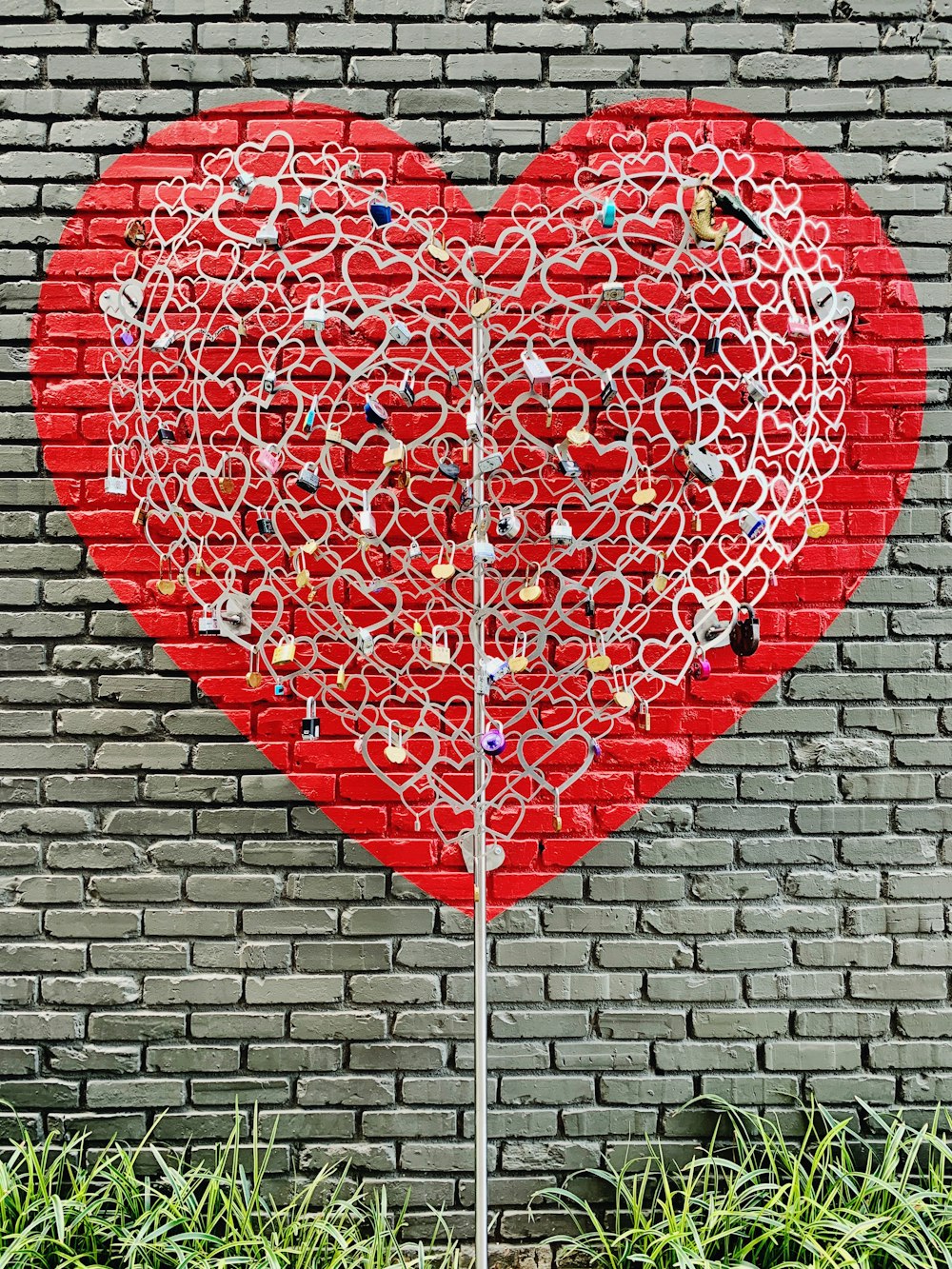 red heart shaped balloon on brown brick wall