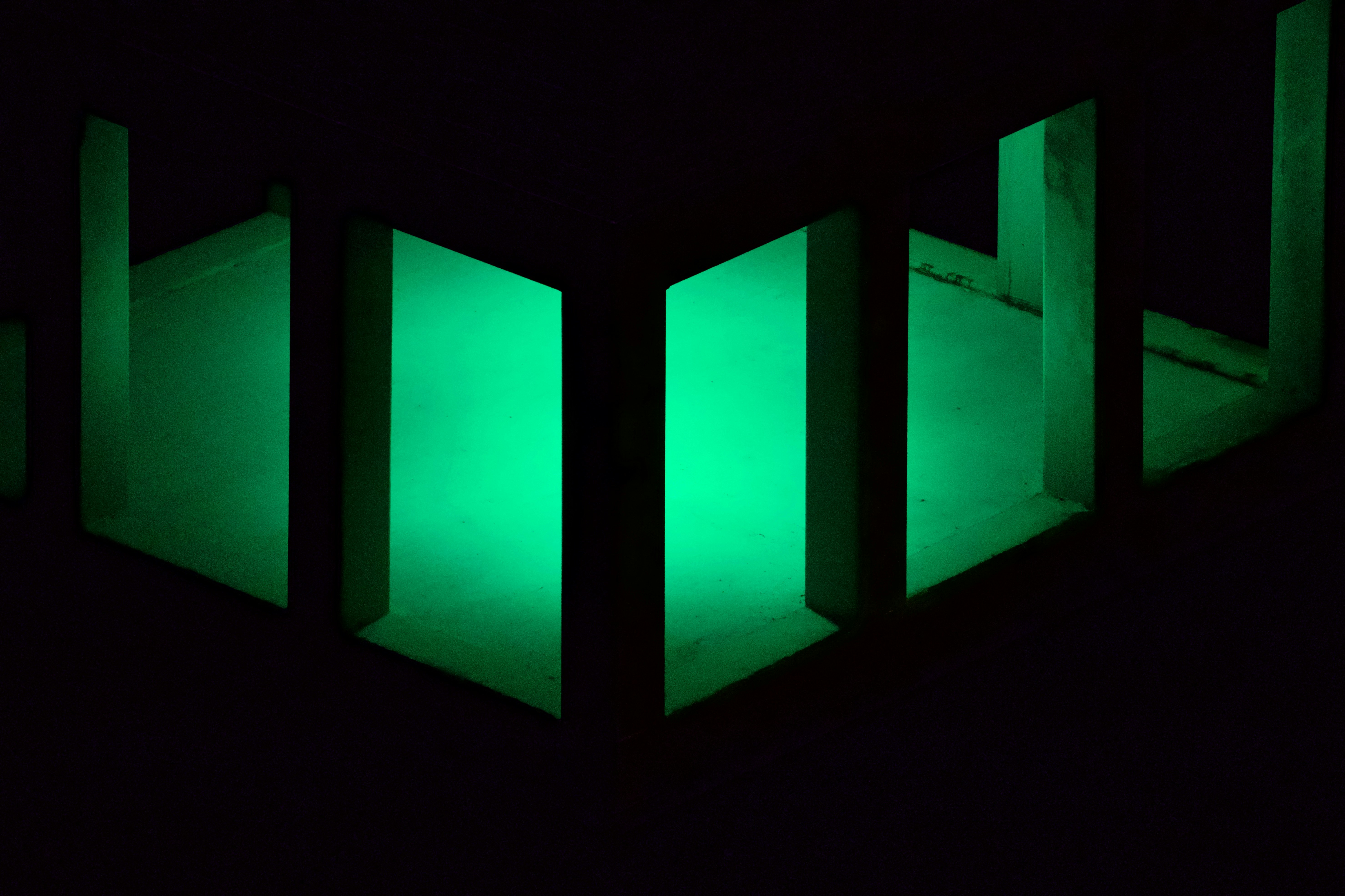 Modern server rack in a dark room with green and blue LED lights
