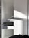 Close-up of a skilled carpenter installing wooden cabinets in a bright, modern kitchen.