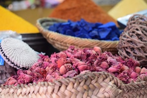 Close-up of traditional African woven baskets filled with freshly gathered herbs and plants