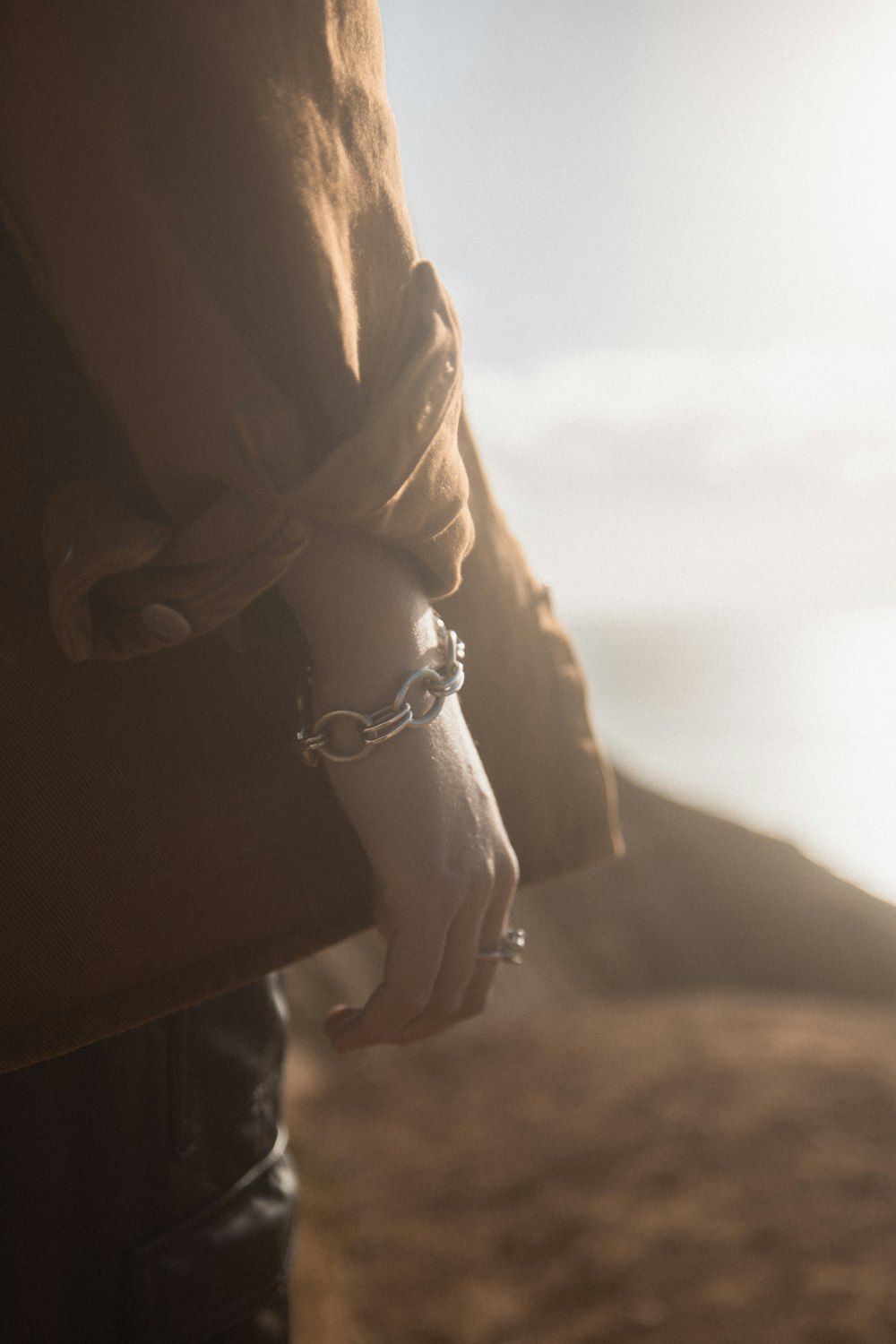 person in black long sleeve shirt wearing silver bracelet