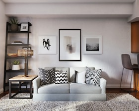 white and black throw pillow on white couch