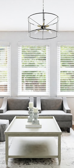 white sectional couch beside white wooden table