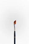 A single paintbrush with a silver ferrule and angled bristles stands upright against a plain white background. The handle is dark with a metallic finish at the top.
