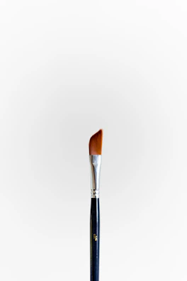 Flammasilk brush being rinsed effortlessly under running water.