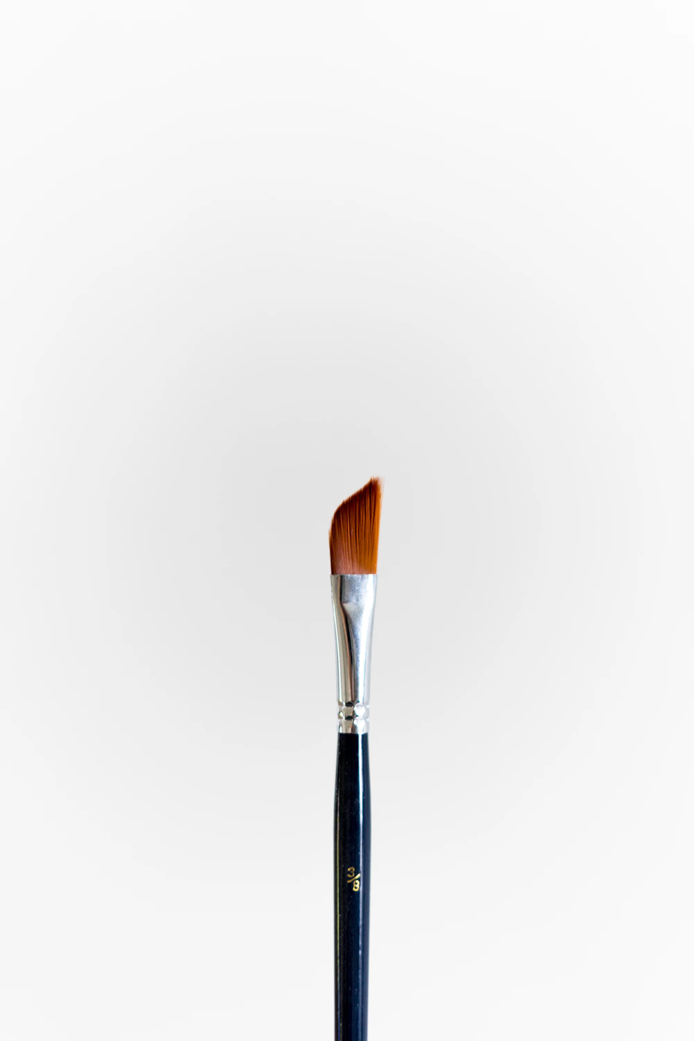 Collection of well-used paint brushes standing in jars