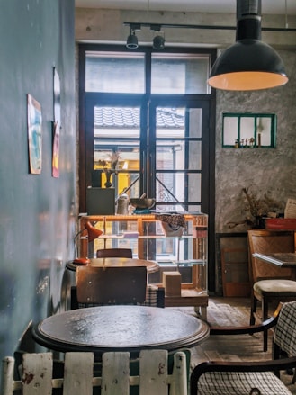 brown wooden chairs and table near window