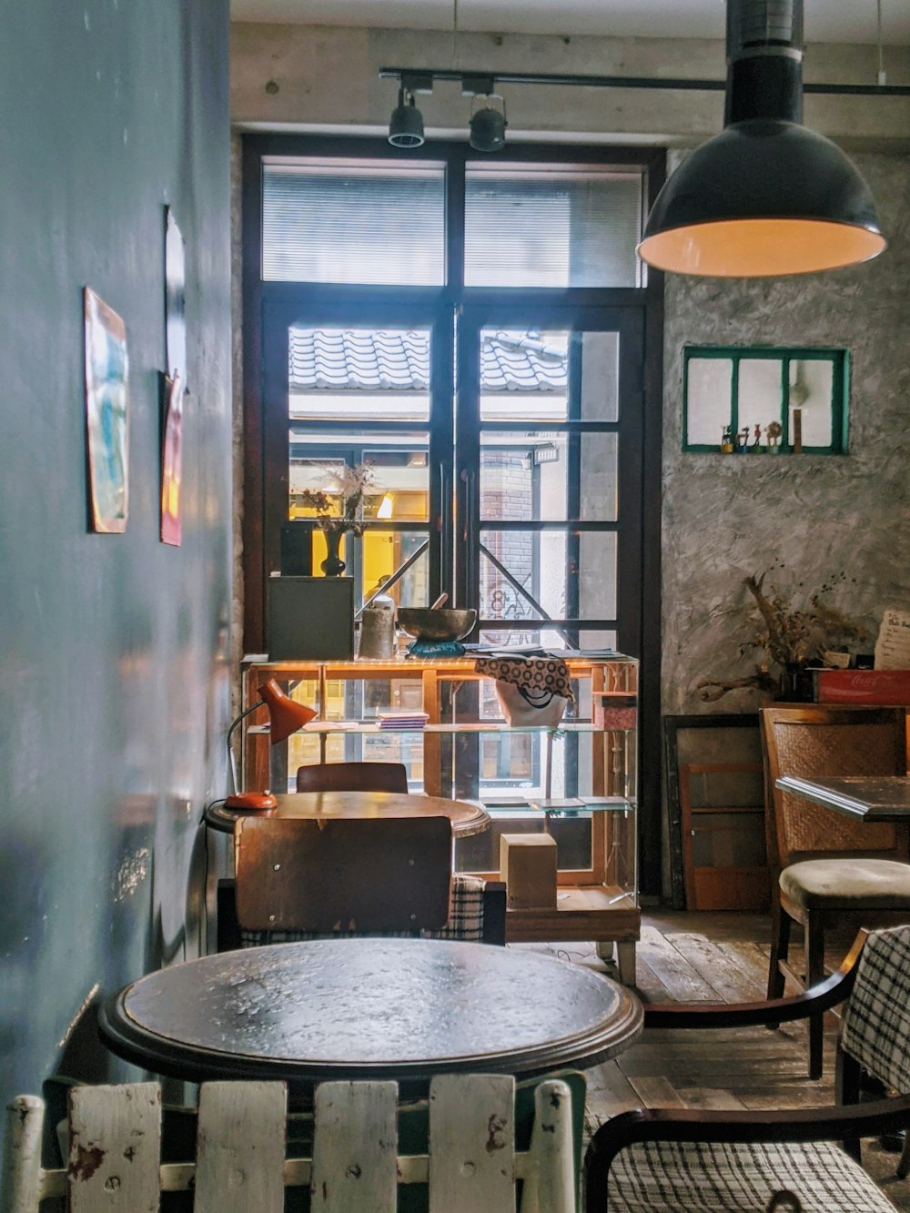 brown wooden chairs and table near window