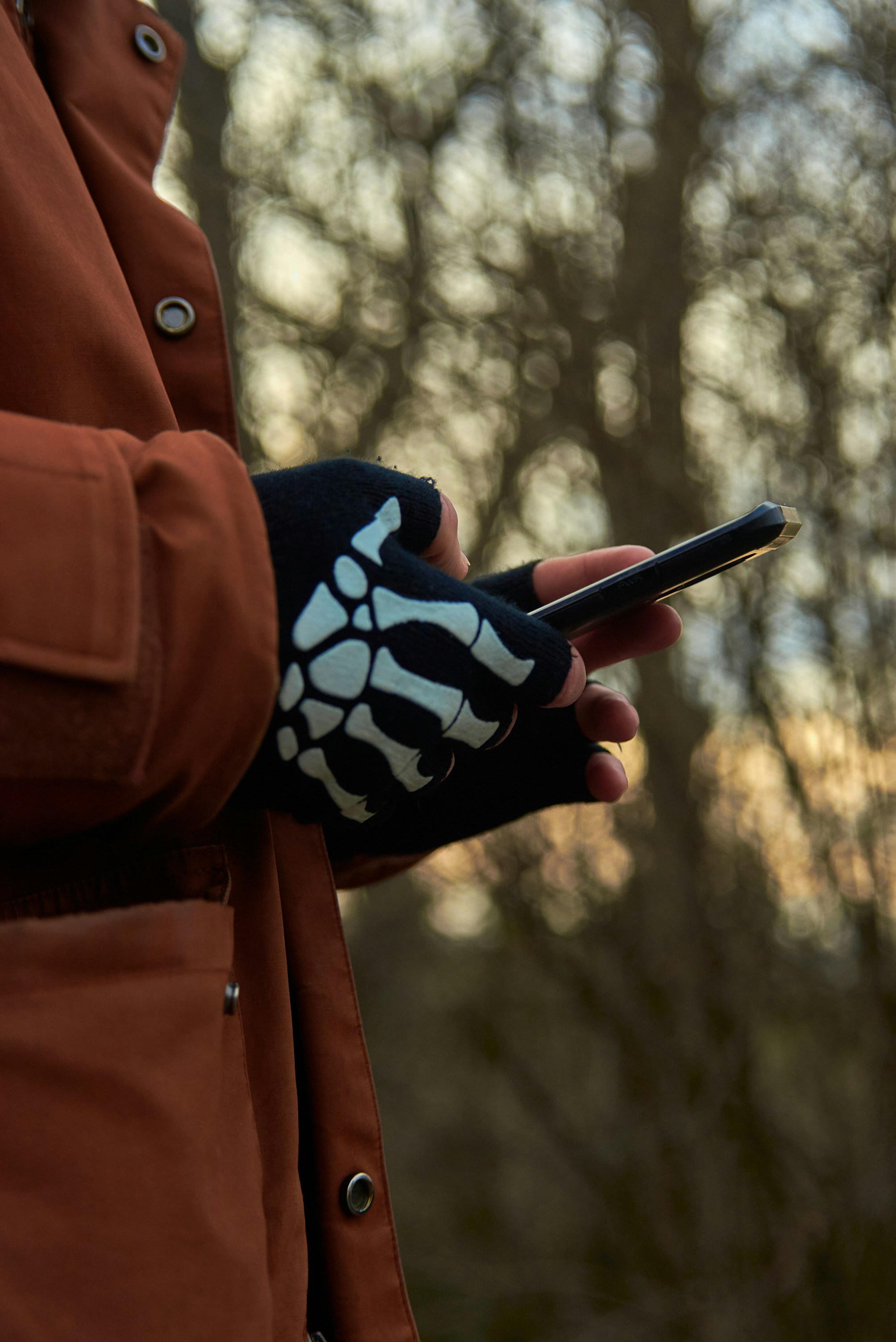 person holding black pen and black and white floral textile