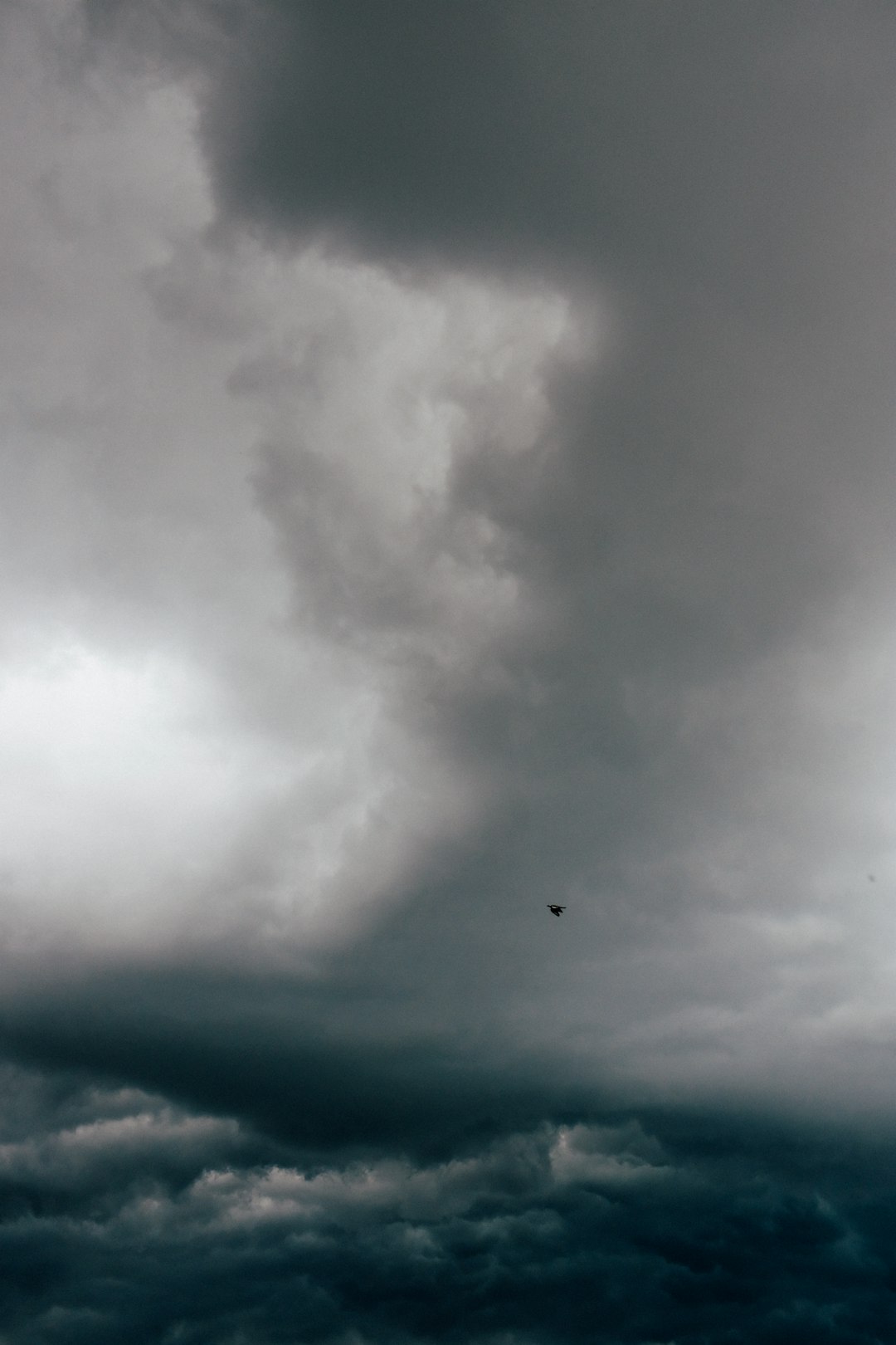 airplane flying over white clouds during daytime