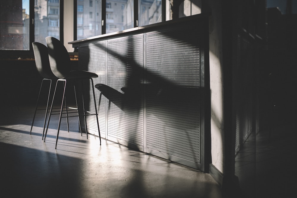 person sitting on chair near window