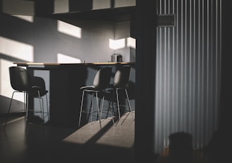 black metal chair near white window blinds