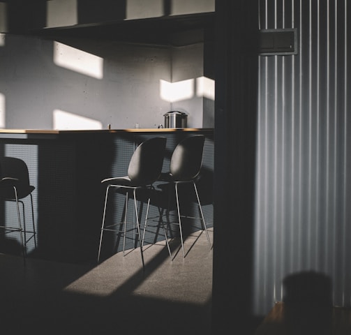 black metal chair near white window blinds