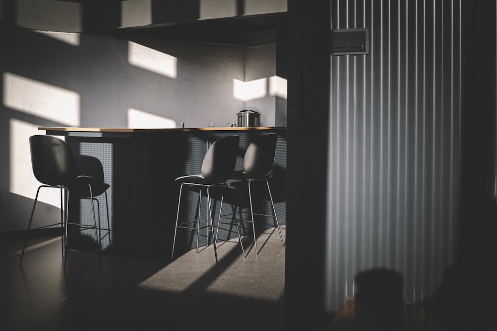 black metal chair near white window blinds