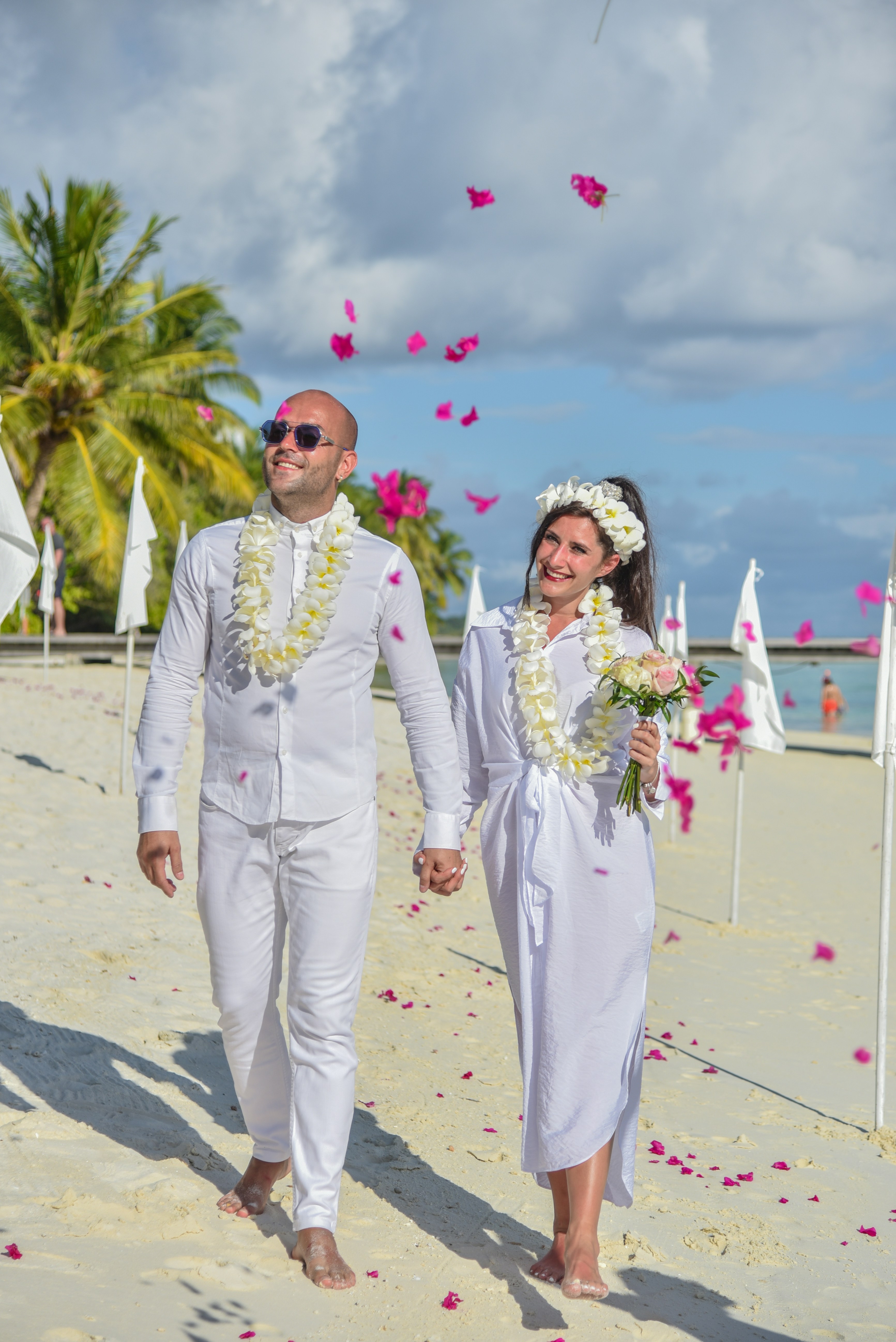 man and woman holding bouquet of flowers