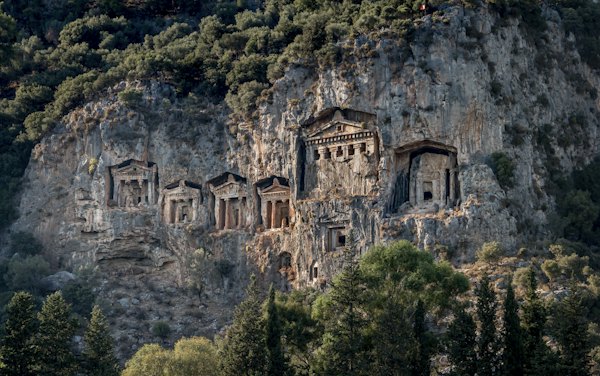 Brown concrete building near green trees during daytime — Dalyan, Turkey