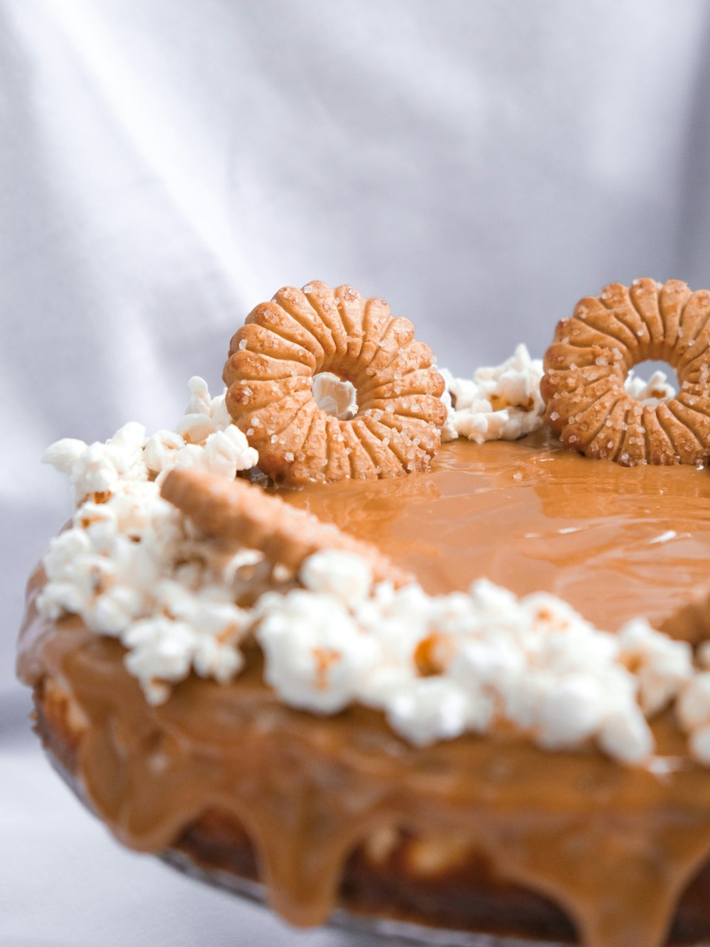 brown and white doughnut on white textile