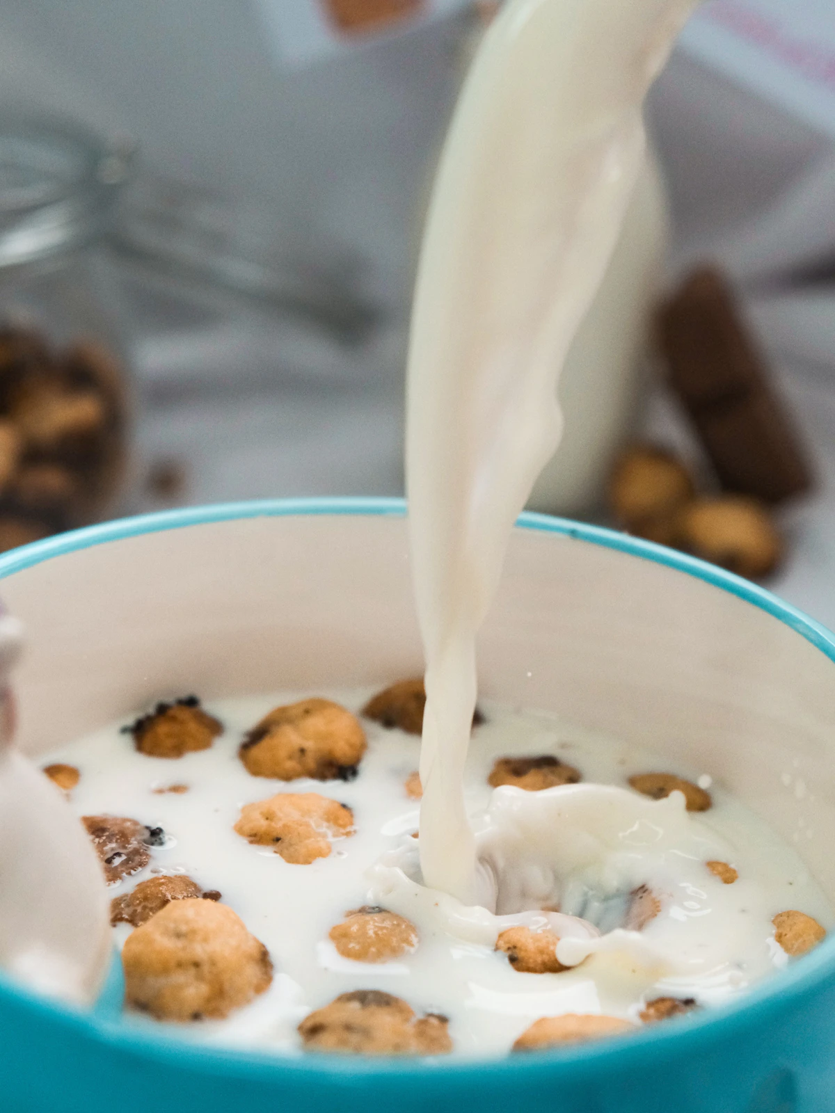 Milk pouring into a bowl of cereal