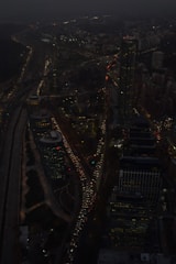 Aerial view of a city with fast-moving traffic at dusk.