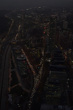 Aerial view of a city with fast-moving traffic at dusk.