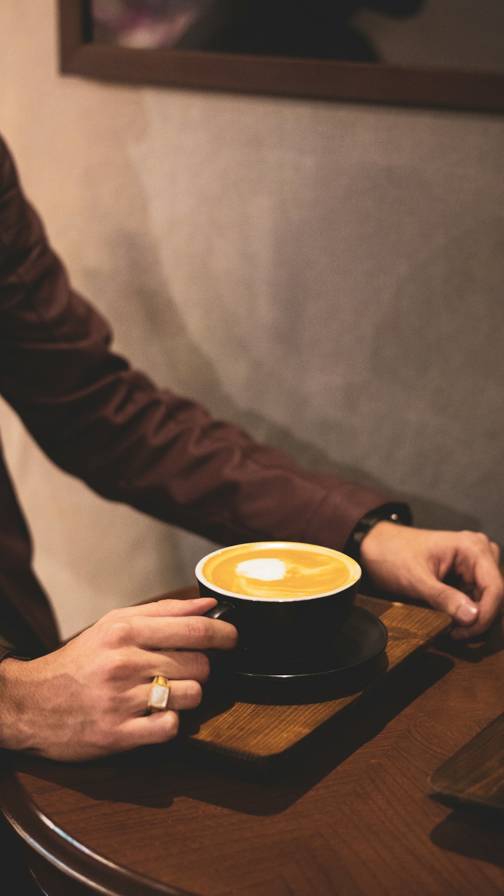 person holding black ceramic mug