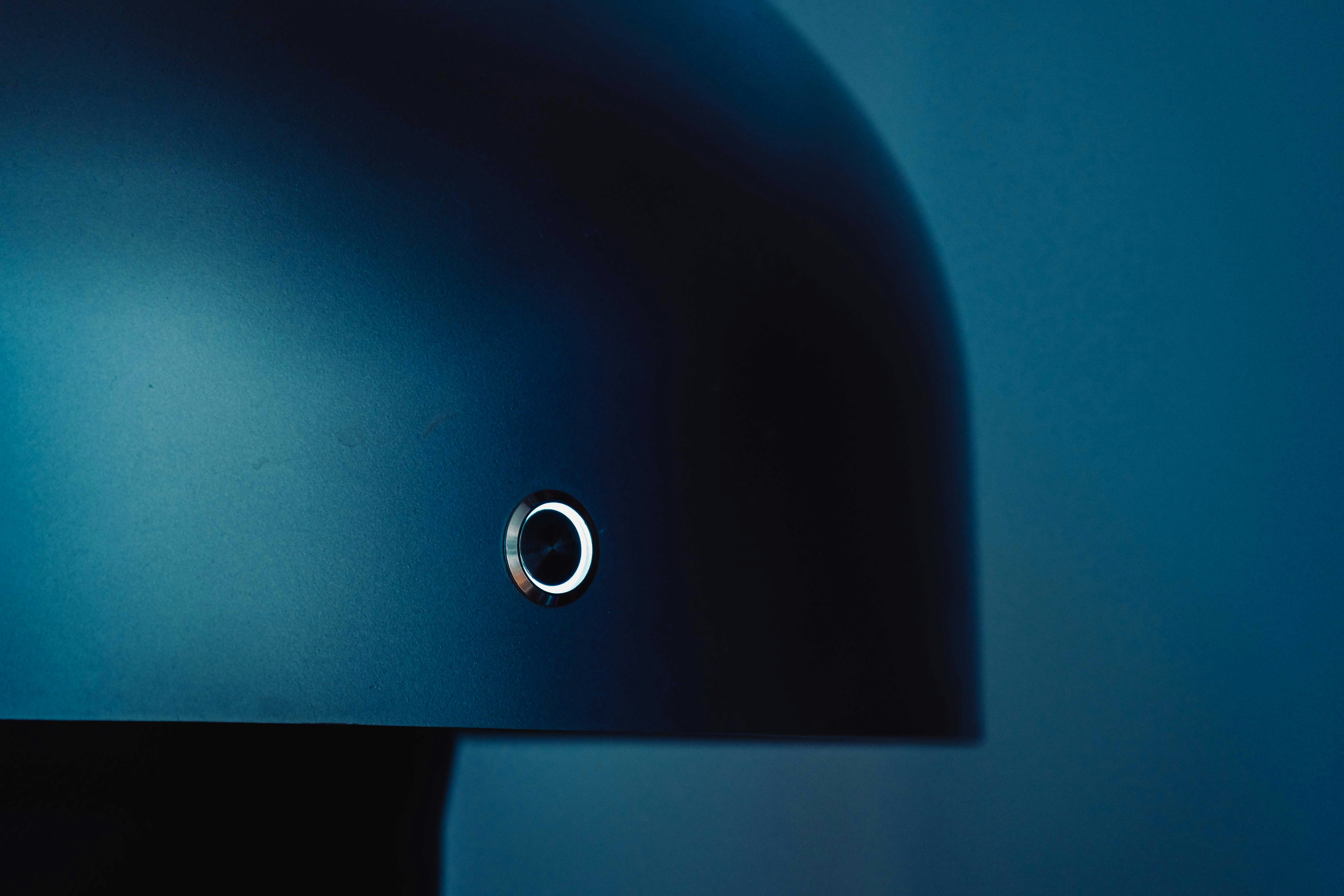 Black round device on blue surface