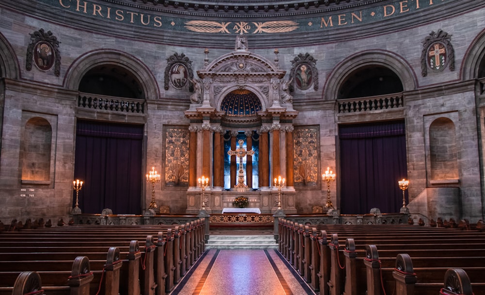 an empty church with pews and chandeliers