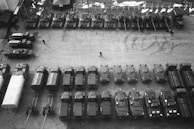 Aerial view of a fleet of transport vehicles lined up in a depot.