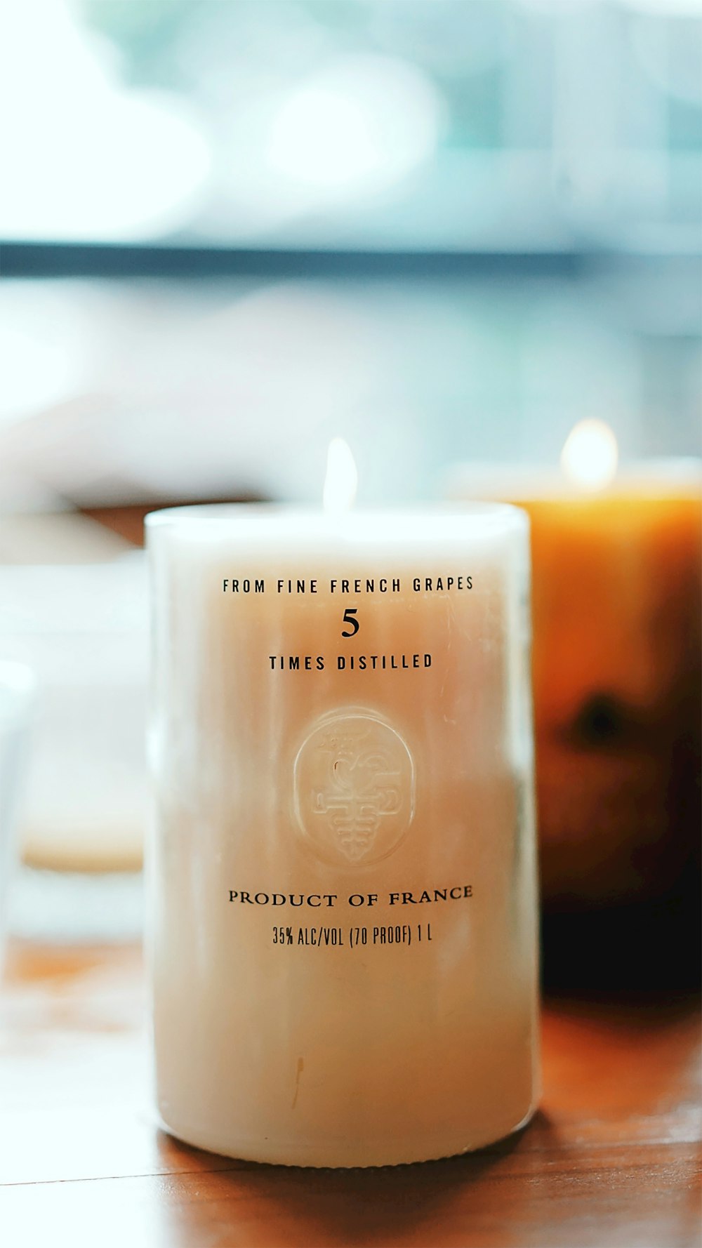 a white candle sitting on top of a wooden table