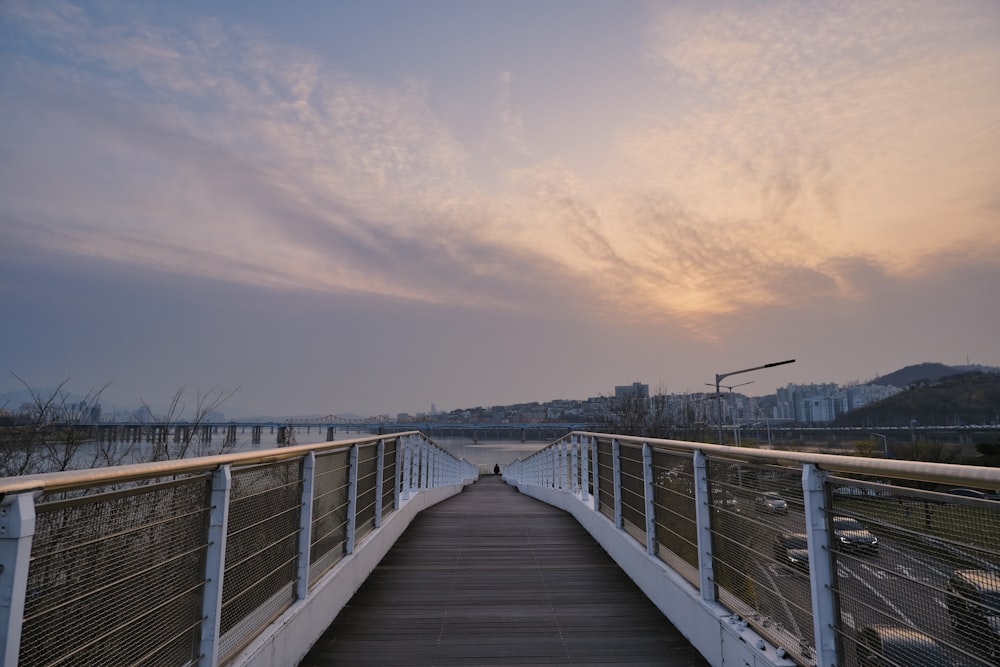 white and blue bridge under white clouds