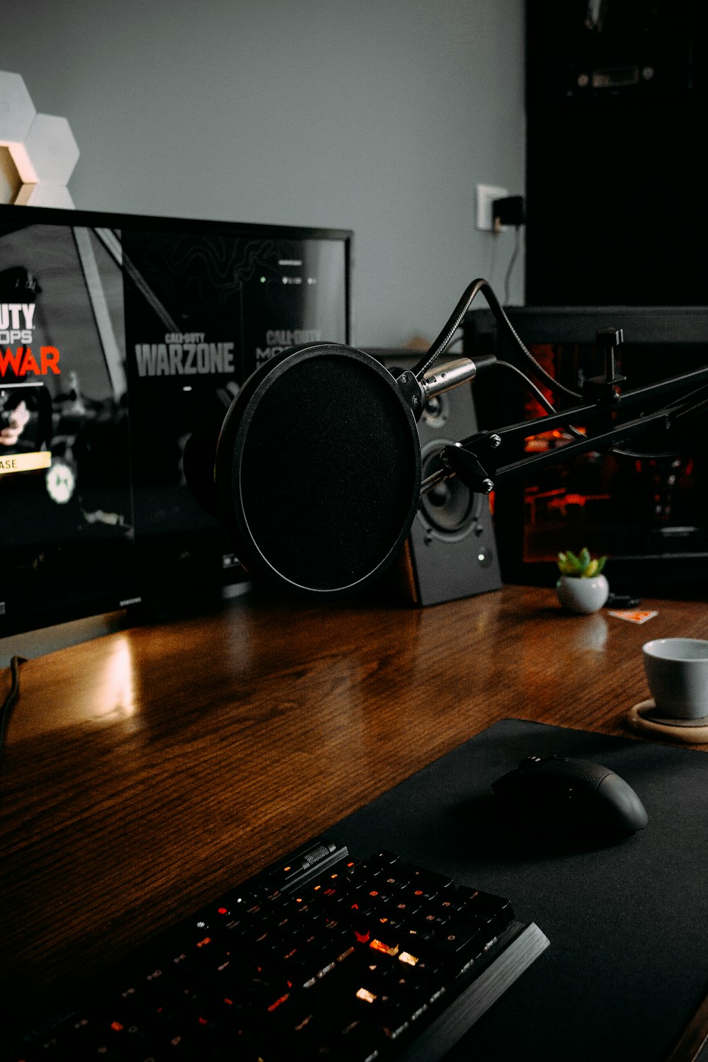 black and gray speaker on brown wooden table