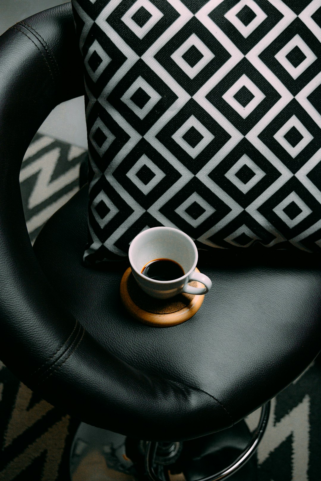 black and white ceramic mug on black leather car seat