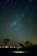 A happy couple looking up at a clear night sky filled with stars during a guided tour.