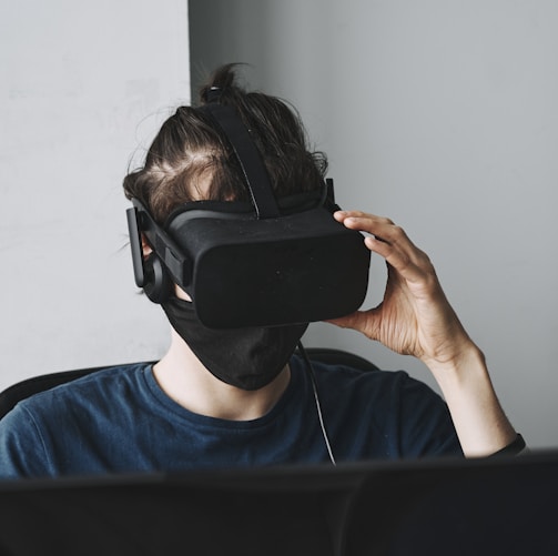 man in blue crew neck shirt wearing black vr goggles