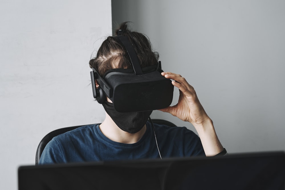 man in blue crew neck shirt wearing black vr goggles