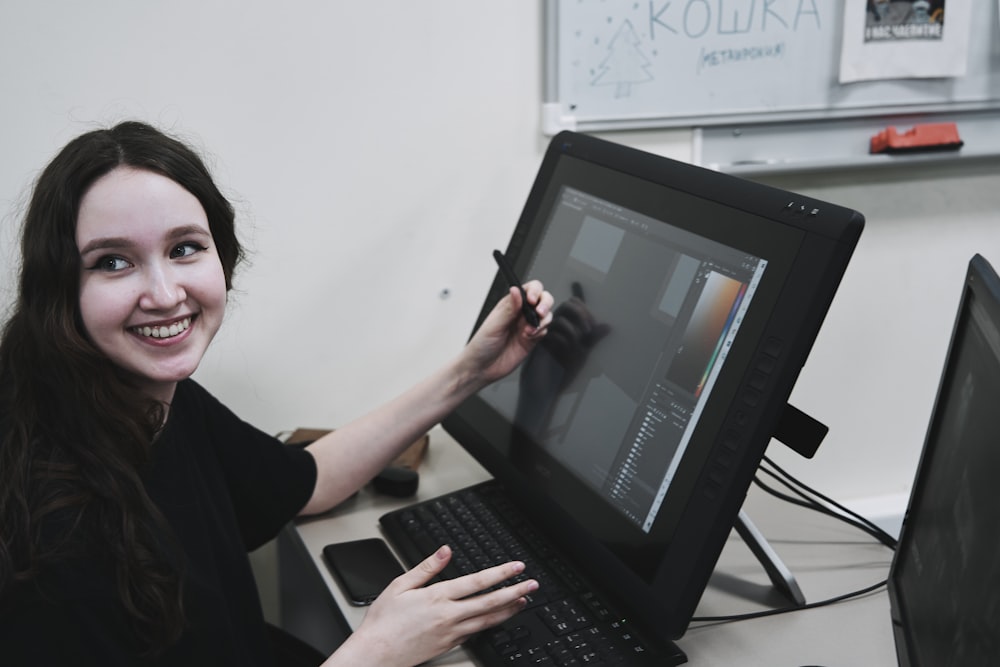 woman in black long sleeve shirt using black laptop computer