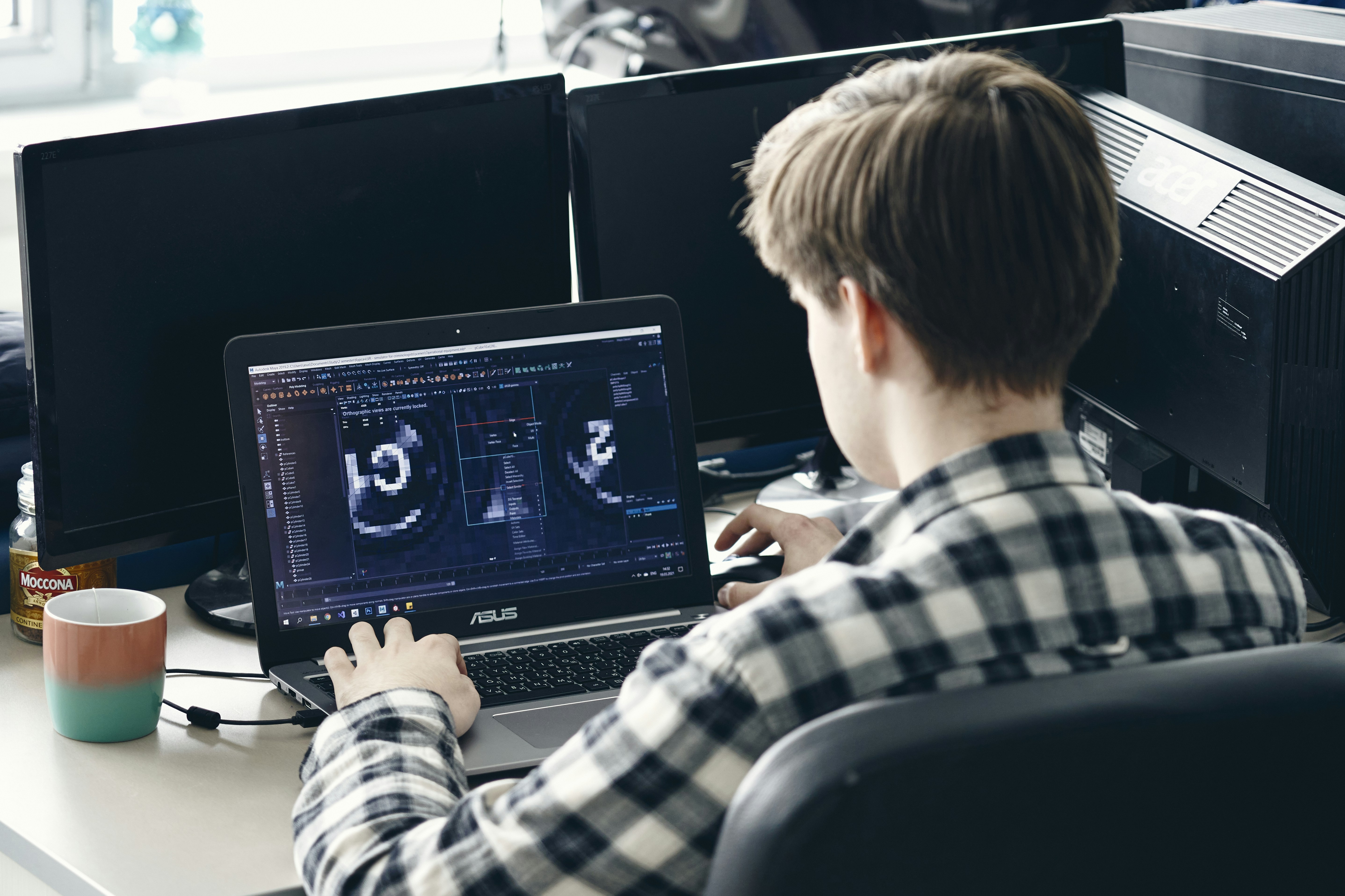 man in black and white plaid dress shirt using black laptop computer