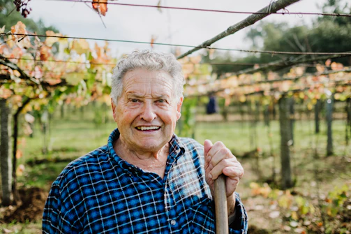 A warm handshake between a financial advisor and a farmer in a sunlit vineyard