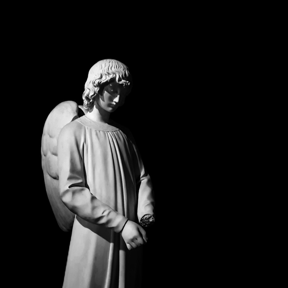 gray scale photo of angel statue