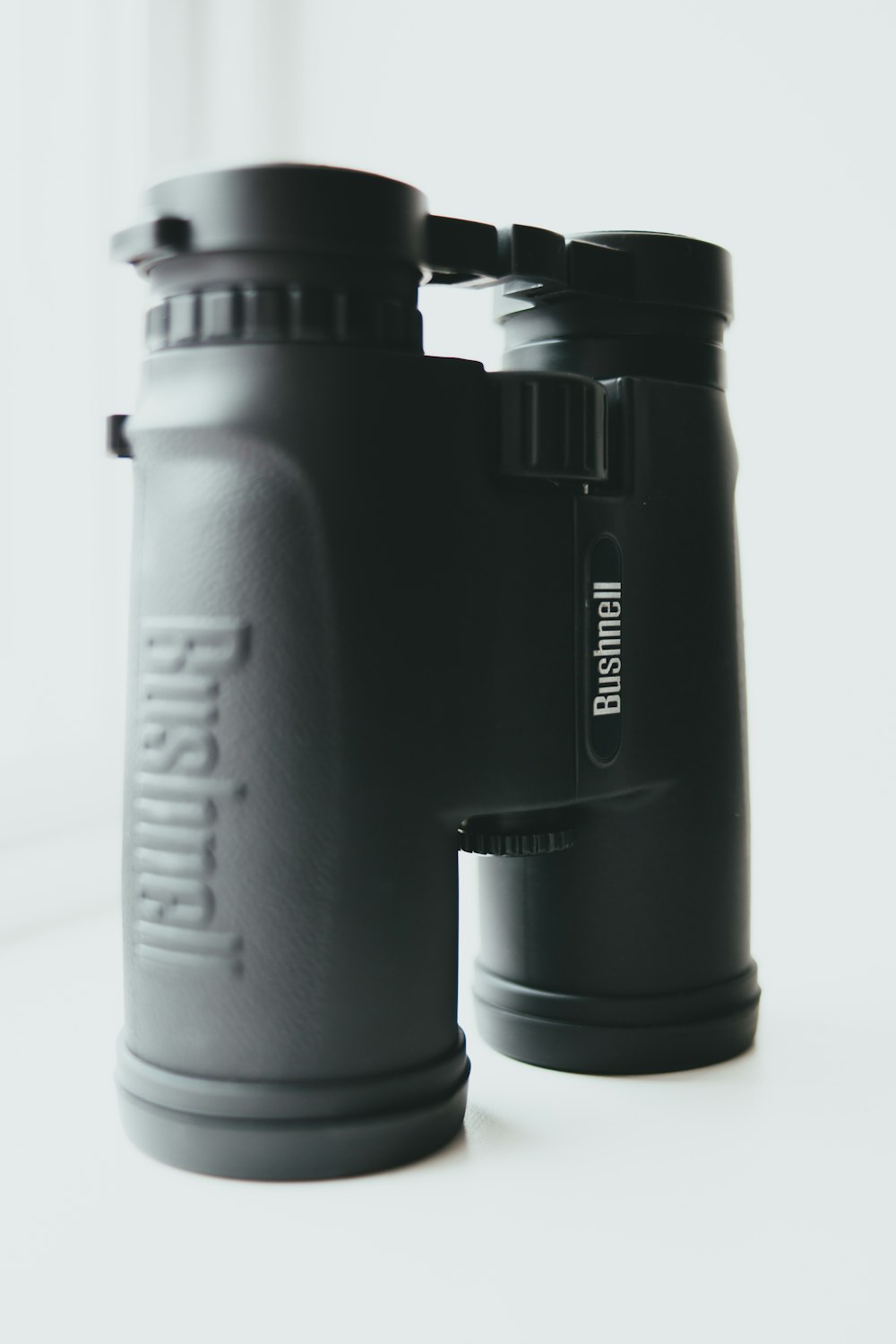 black binoculars on brown wooden table