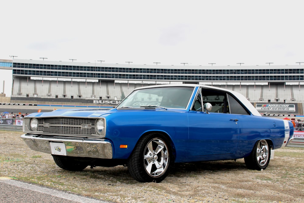 blue car on gray asphalt road during daytime