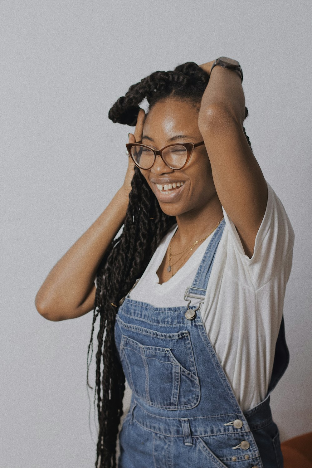 woman in blue denim vest and white shirt