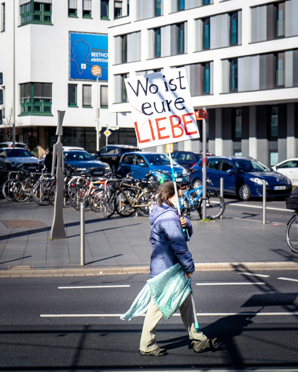 woman in green dress walking on pedestrian lane during daytime