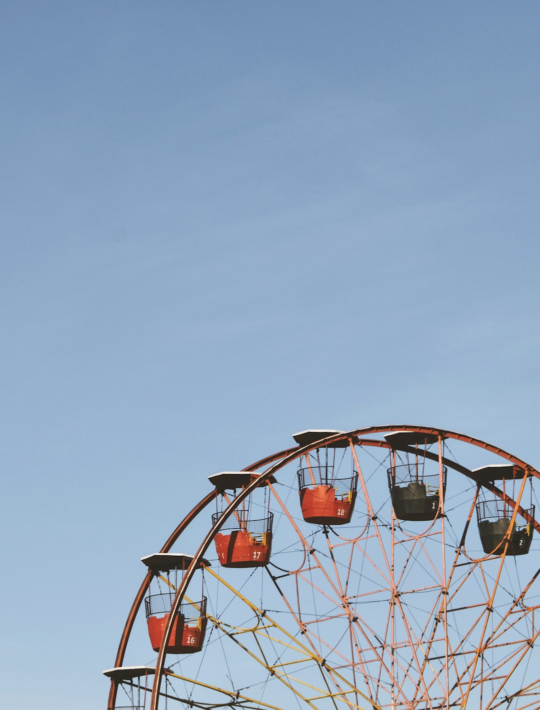 white and red ferris wheel under white sky during daytime