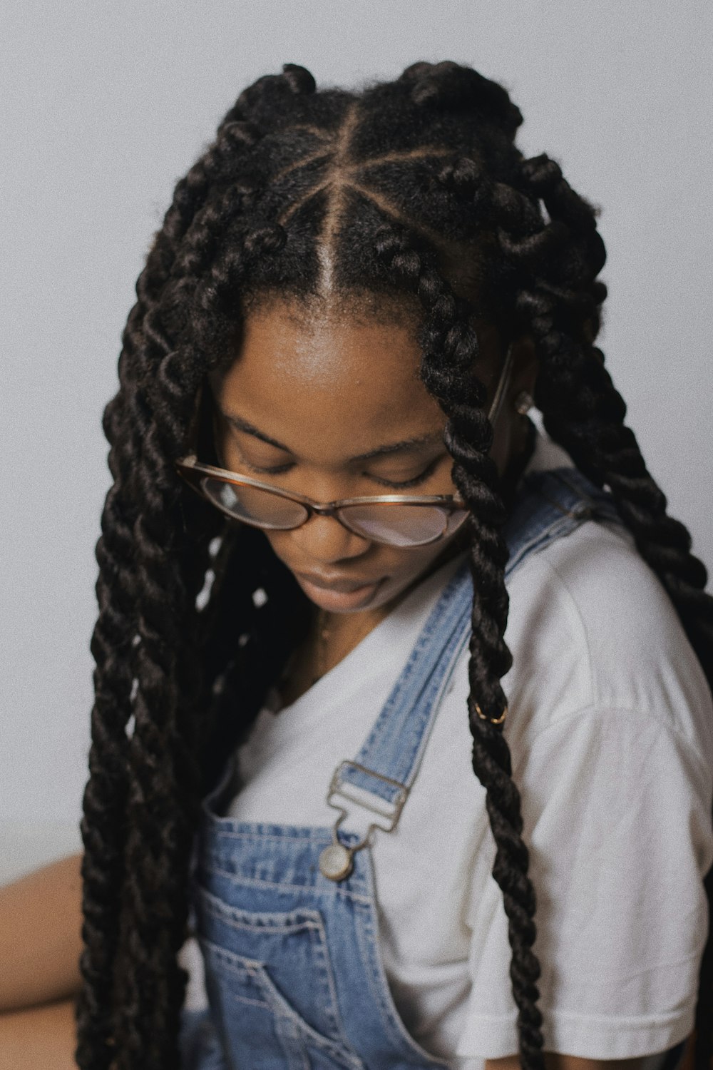 woman in white shirt wearing black framed eyeglasses