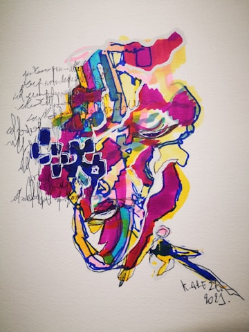 An abstract and colorful artwork with various vibrant hues, including red, blue, yellow, and pink. It appears to include abstract shapes and lines with a possible figure or face partially visible among the colors. Handwritten text and doodles are blended into the design, creating a layered and textured appearance.