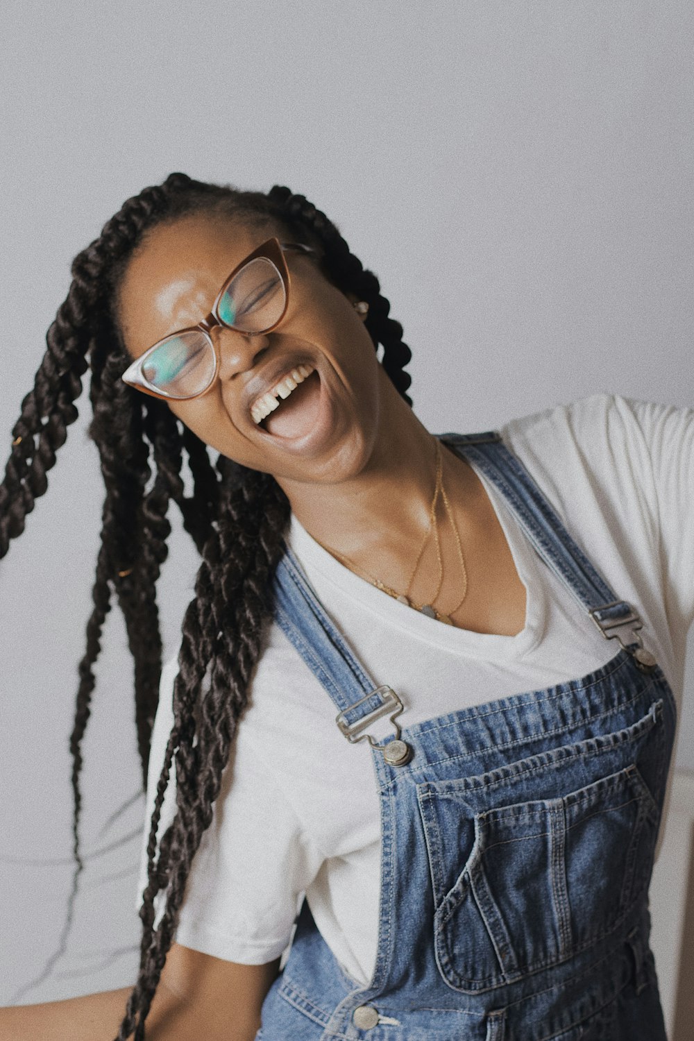 woman in blue denim jacket wearing black framed eyeglasses